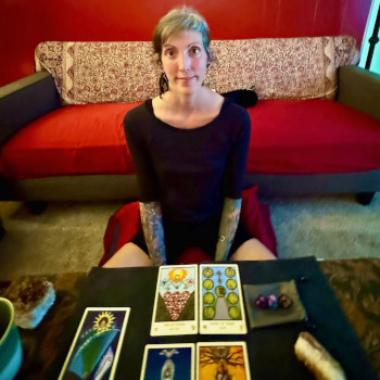 Esme seated at an tarot reading event in Portland, Oregon.